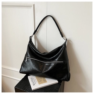 Detail of a vintage black hobo bag featuring oily crinkle texture and front metal zipper