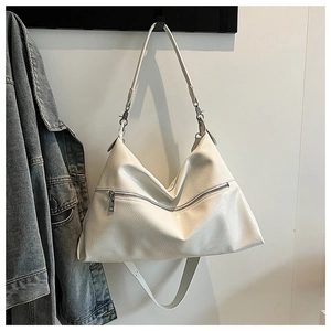 Close-up of a white wrinkled patent leather hobo bag featuring decorative front zipper