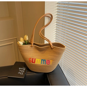 Detail of summer woven tote bag with colorful summer embroidery and light interior lining