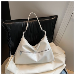 Detailed close-up of cream white hobo bag showing texture and silver metal zipper accent