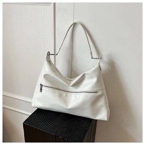 Detail of creamy white large hobo bag with smooth pebble texture and metal zipper
