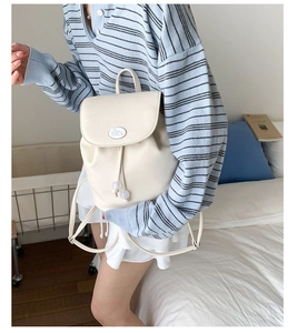Detail of off-white lychee texture leather backpack with drawstring and rabbit logo