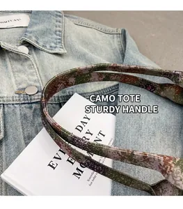 Detailed macro view of durable camo pattern woven shoulder strap on casual tote bag