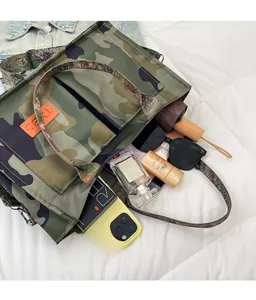 Flat lay of camouflage tote bag with daily essentials like sunglasses and sunscreen