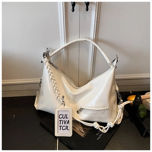 Detail of white PU leather hobo bag featuring woven strap and Cultiva TCR tag