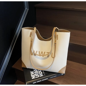 Detailed close-up of retro large-capacity tote bag with textured pebbled leather on wood