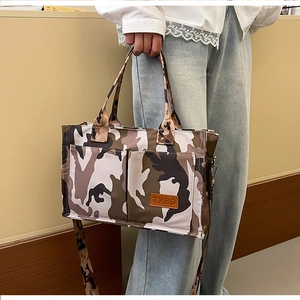 Detail of camouflage tote bag with double pockets and adjustable shoulder strap