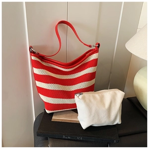 Detail of red and white striped knit tote bag with matching canvas pouch and red straps