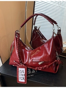 Large burgundy patent leather tote bag with braided handle and glossy wrinkled texture