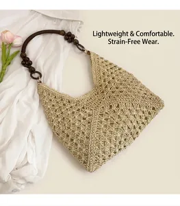 Detail of hollow crochet straw bag featuring unique dark brown wooden bead shoulder strap