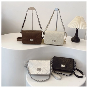 Detailed display of four quilted chain handbags in brown, beige, silver, and black