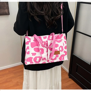 Rear view of a model wearing the pink leopard print tote bag with multiple pockets
