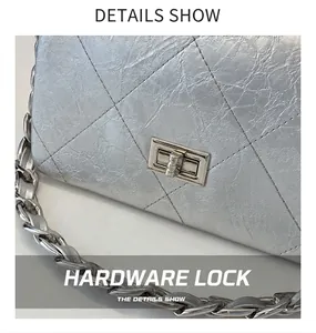 Detailed macro view of silver quilted leather finish and metallic rectangular turn-lock closure