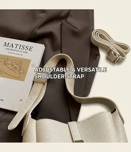Detail of off-white lychee texture leather bag with adjustable strap and buckle