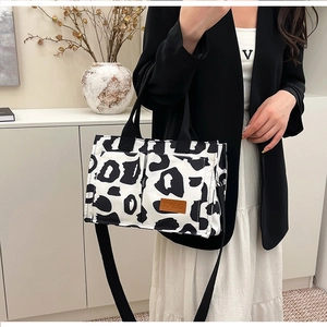 Detail of leopard print tote bag showing large pockets and adjustable shoulder strap