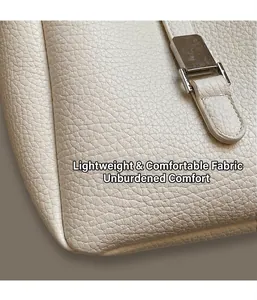 Detail of creamy white bucket bag featuring silver metal buckle and lychee leather texture
