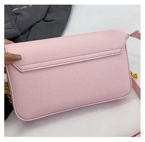 Close-up of pink leather crossbody bag showing detailed stitching and back slit pocket