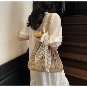 Detail of hand-woven crochet tote bag featuring lace bow and mesh hollow texture