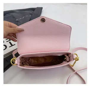 Detailed interior of the pink crossbody bag with a main pocket and zipper compartment