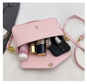 Detail showing the spacious interior of pink lychee leather chain crossbody bag