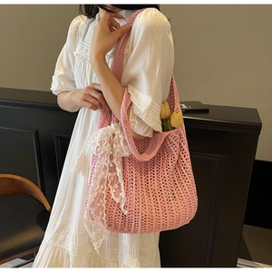 Pink hand-woven crochet bag with delicate white lace bow detail and tulip flower