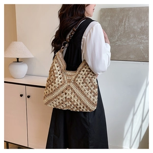 Detail of hand-crocheted straw tote bag featuring wood bead straps and geometric patterns