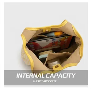 Macro view of a large capacity striped tote bag interior showing compartments and storage