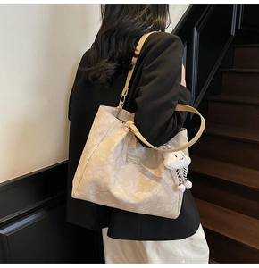 Vue détaillée du sac cabas beige en jacquard fleuri avec un charm nuage mignon