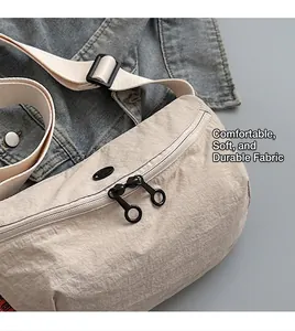 Detail of light beige crescent crossbody bag with durable soft pleated nylon texture