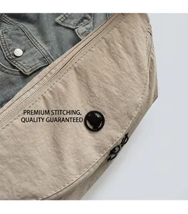 Close-up of beige nylon crossbody bag featuring a round bear logo and neat stitching