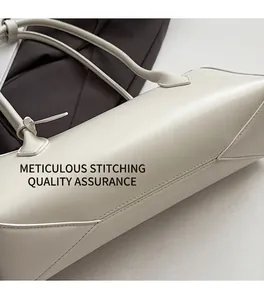 Detail showing high-quality stitching and smooth leather texture on white baguette bag