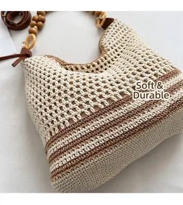 Detail of bohemian woven tote bag showing leather strap with wooden beads and crochet texture