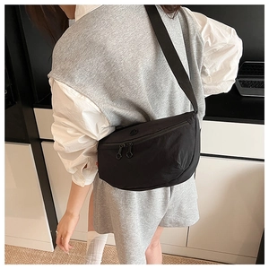 Detail showing back view of black nylon half-moon crossbody bag with adjustable strap