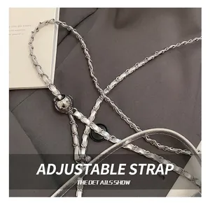 Close-up of adjustable silver metal chain strap with woven leather and sphere buckle