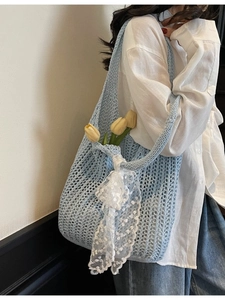 Light blue knit woven tote bag with white lace ribbon and yellow tulips on a white shirt