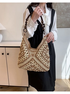 Straw shoulder bag with wooden bead handles and hollow weave for summer beach vacations