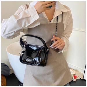 Detail of black glossy handbag with silver Fashion plate and balloon dog charm
