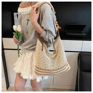 Close-up of beige crochet tote bag with wooden bead straps and secure zipper closure