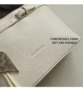 Detailed macro of white litchi pattern leather with silver buckle and leaf ornament