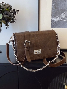 Brown quilted crossbody bag with vintage wrinkled leather texture and silver chain strap
