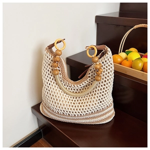 Detail of bohemian hollow knit tote with wooden rings and vintage beaded handle