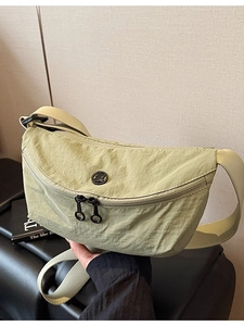 Minimalist light green nylon crossbody bag with dual zipper and wide shoulder strap