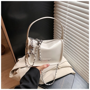 Detail of cream white PU crossbody bag with silver chain and cute balloon dog charm