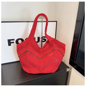 Gros plan détaillé du sac cabas au crochet rouge avec motifs ajourés et couture verte