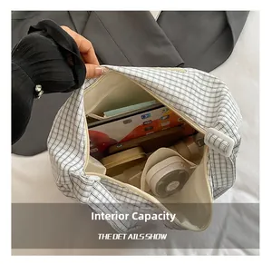Spacious interior of black and white gingham tote bag with tablet and cosmetics