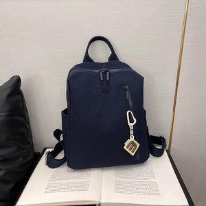 Detail of dark blue waterproof nylon backpack with minimalist design and m-tag