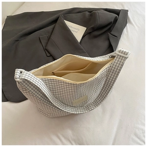 Detail view of large capacity hobo bag interior with zip pocket and black-white pattern