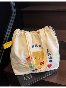 Minimalist beige drawstring tote bag with cute bear embroidery and yellow handle