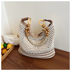 Detailed macro view of crochet tote bag featuring wooden beads and secure zipper closure