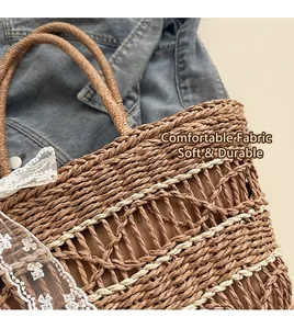 Macro view of woven straw tote bag with white lace ribbon detail on denim jacket background